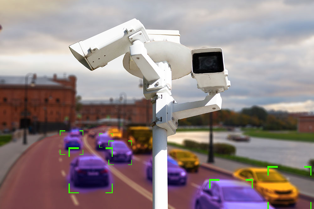 The concept of video surveillance and security technology. CCTV camera on the background of a road bridge with traffic in cloudy weather. Definition zone.